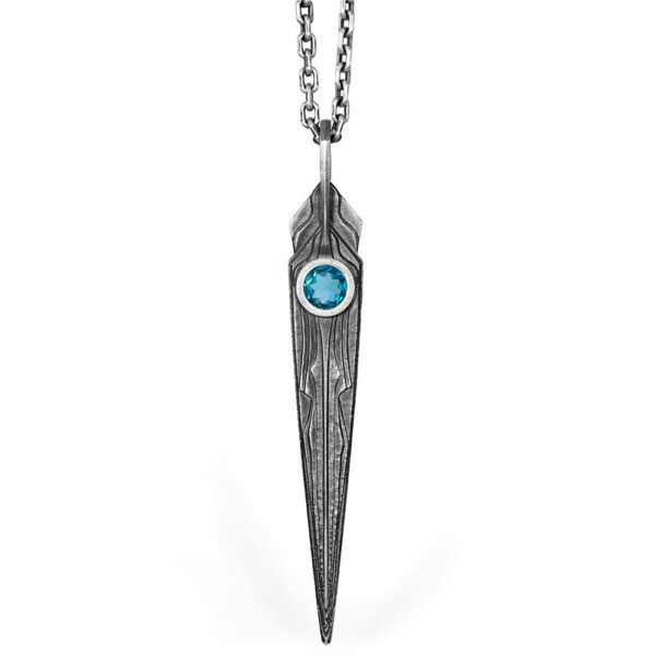 The Needle Necklace 3i in oxidized sterling silver, a tapered blade pendant set with a faceted blue stone, by Ether Eleven.