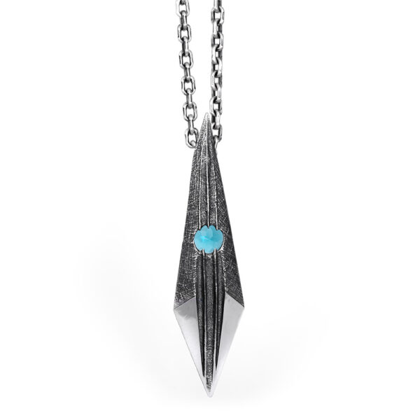 The Shard Pendant in oxidized sterling silver, a faceted blade form set with a Paraiba tourmaline, on a sterling silver chain by Ether Eleven.